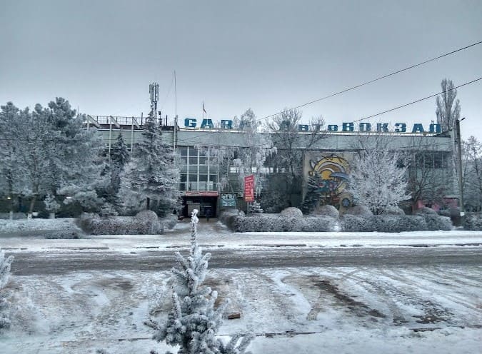 the facade of the Balti bus station, winter, trees and bushes
